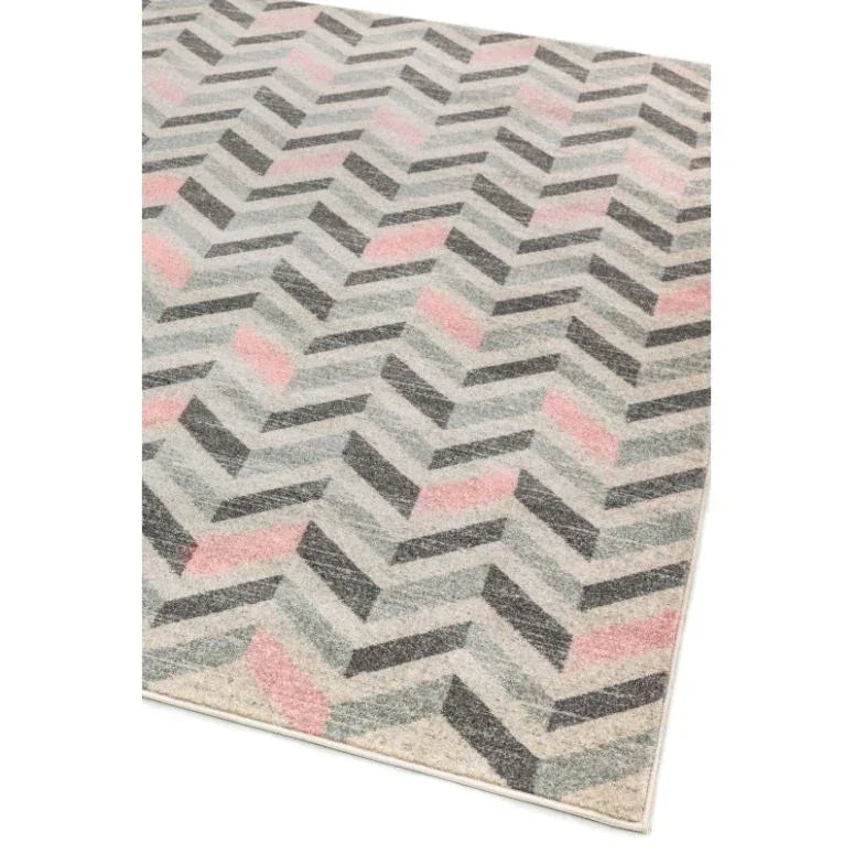Chevron pattern rug with grey and pink tones viewed from an angle