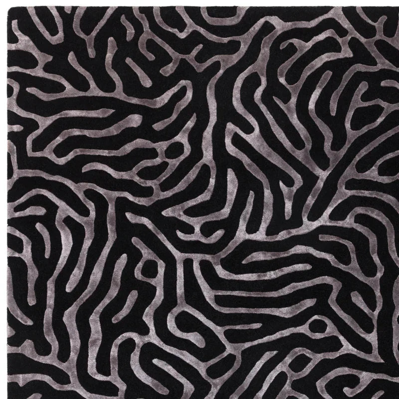 Black and grey rug with abstract geometric pattern and textured surface