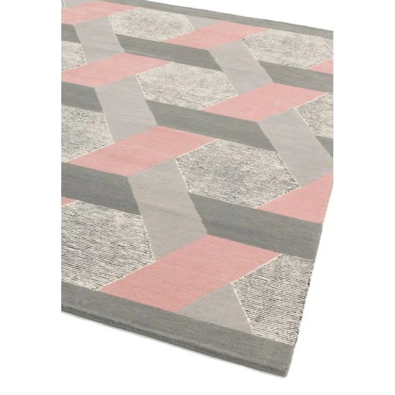 Geometric rug with pink, grey, and cream pattern, angled corner view