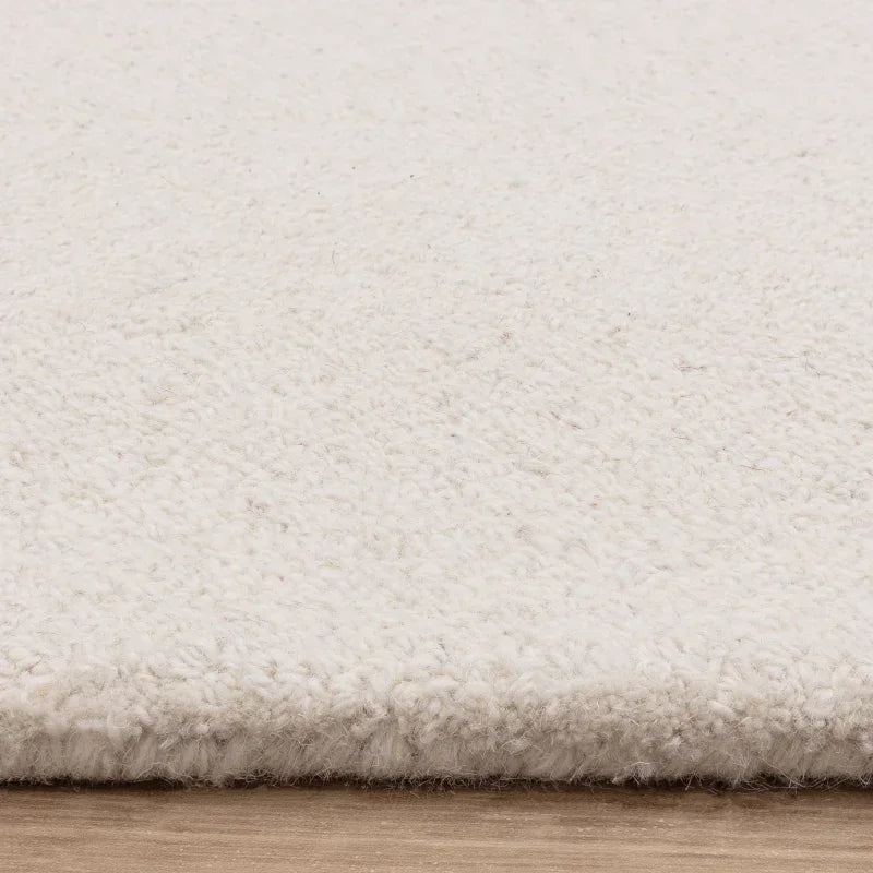 Close up of cream wool rug texture on wooden floor