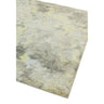 Abstract area rug with grey, beige, and yellow tones, close view of textured corner