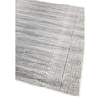 Grey patterned area rug with textured border and circular detailing, angled corner view