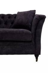 Three-seat sofa upholstered in grey velvet with a tufted backrest and curved armrests, featuring a decorative throw pillow and elegant wooden legs
