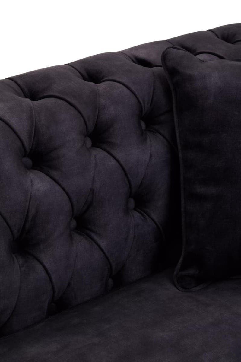 Three-seat sofa upholstered in grey velvet featuring a tufted backrest and a matching cushion, showcasing a luxurious and modern design