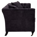 Three-seat sofa upholstered in grey velvet, featuring a tufted backrest and plush cushions. The sofa has a sleek silhouette with gently curved arms and tapered wooden legs