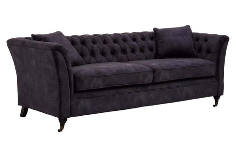Three-seat sofa upholstered in grey velvet with a tufted backrest and two matching cushions, featuring elegant curved arms and tapered wooden legs