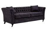 Three-seat sofa upholstered in grey velvet with a tufted backrest and two matching cushions, featuring elegant curved arms and tapered wooden legs
