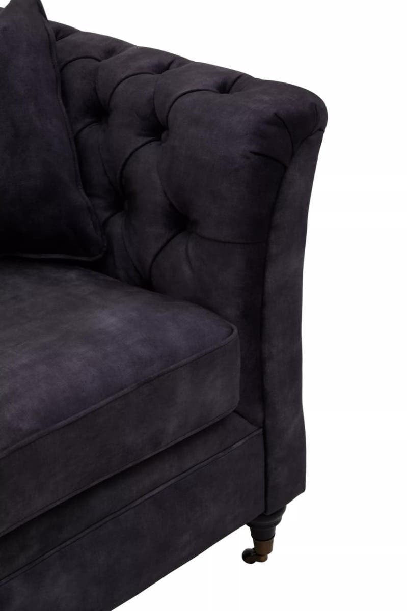 Grey velvet three-seat sofa featuring a tufted design on the backrest and armrest, with elegant curved lines and wooden legs. The fabric has a soft, plush texture, adding a touch of sophistication to any living space