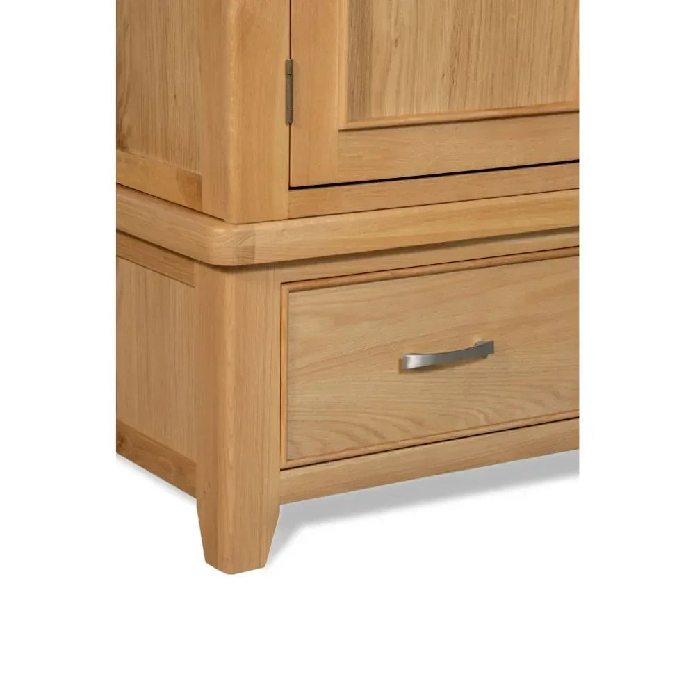 Oak 2-door wardrobe lower corner showing drawer with metal handle and wood grain detail