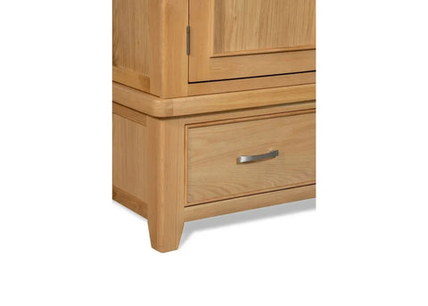 Oak 2-door wardrobe lower corner showing drawer with metal handle and wood grain detail