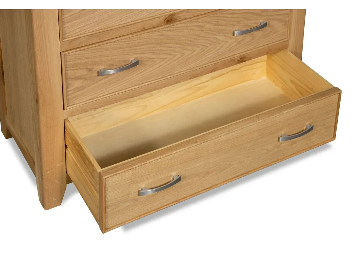 Oak chest of drawers with bottom drawer open, showcasing metal handles and wood grain