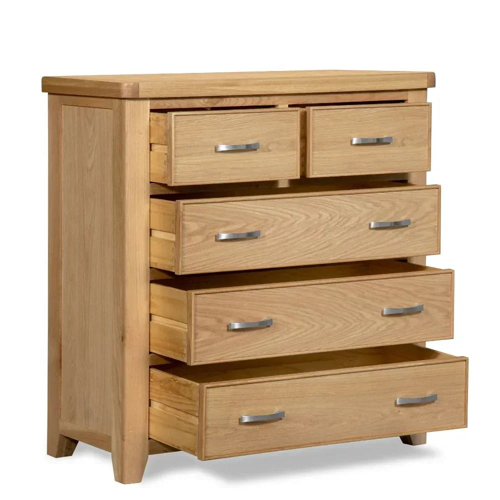 Oak chest of drawers with metal handles and all drawers open, angled side view