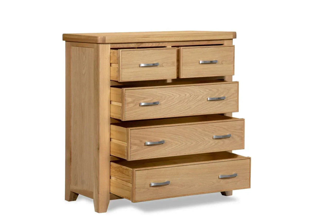 Oak chest of drawers with metal handles and all drawers open, angled side view