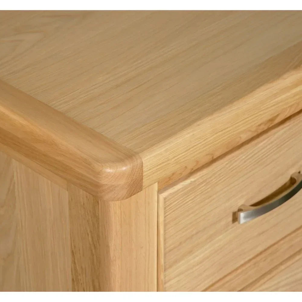 Light oak chest of drawers corner with silver handle and smooth wood grain finish
