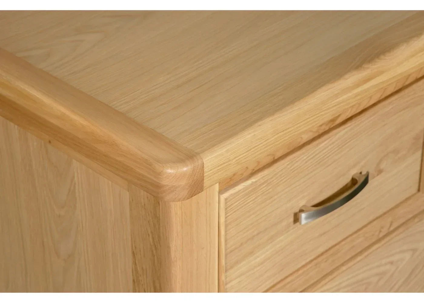 Light oak chest of drawers corner with silver handle and smooth wood grain finish
