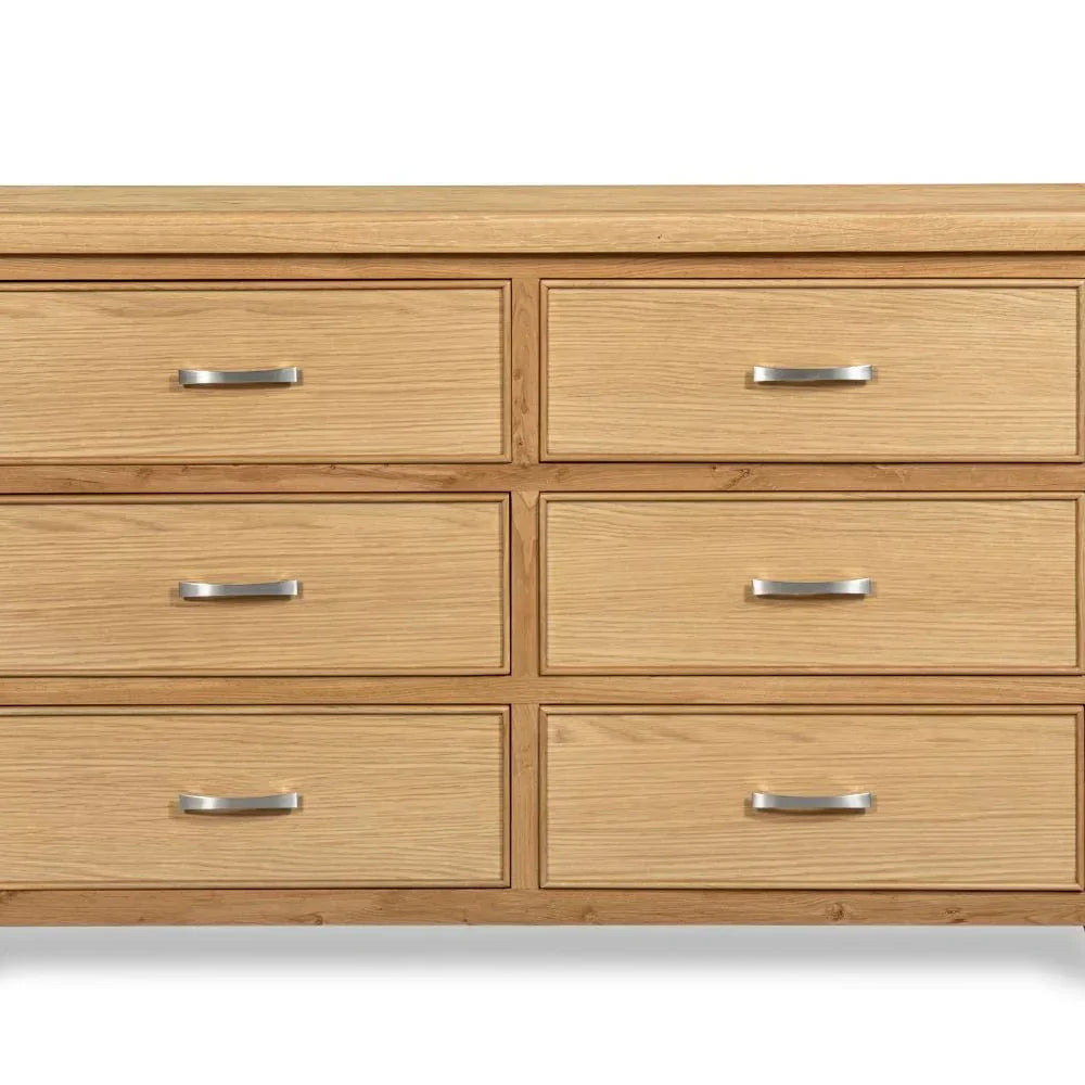 Oak 6 drawer chest with silver handles, wood grain finish, shown from the front