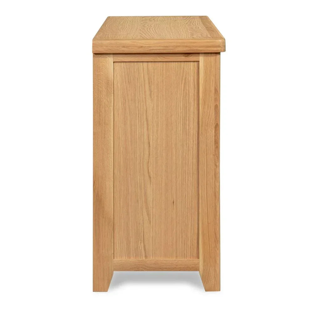 Side view of light oak 6 drawer chest showing wood grain and panel detail