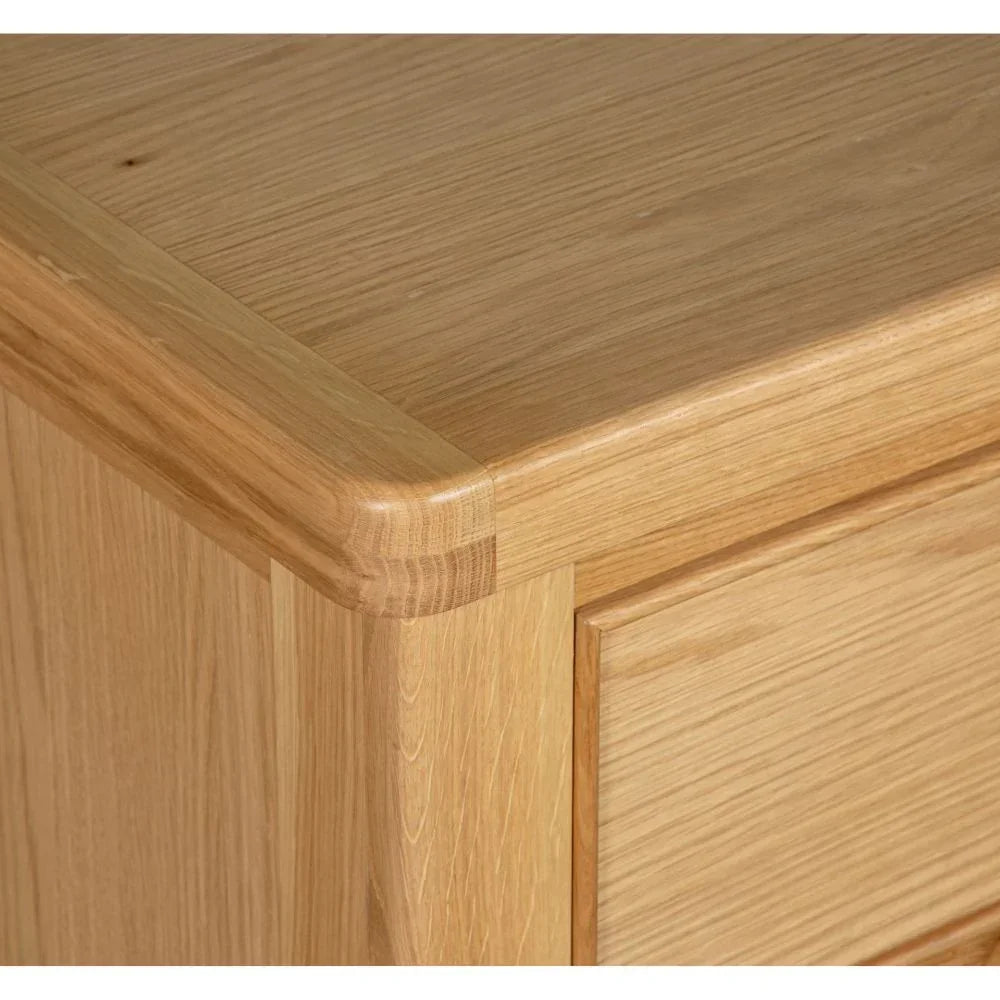 Oak chest of drawers corner detail showing smooth finish and metal handle