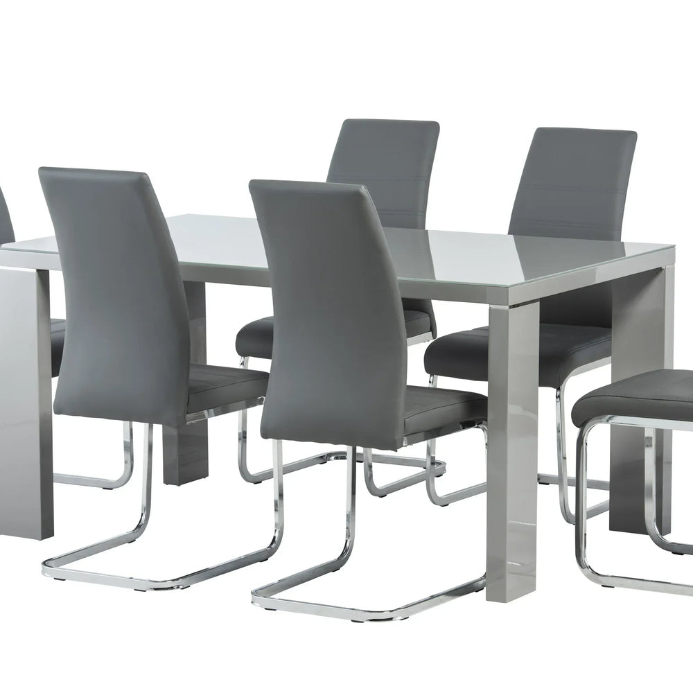 Grey dining table set with six faux leather chairs and chrome legs on white background