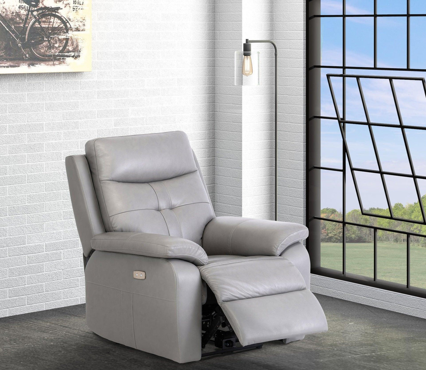 Grey leather recliner armchair with footrest in modern living room by window