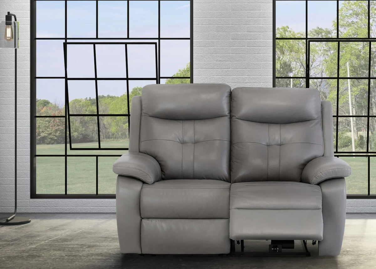 Grey leather reclining sofa with padded armrests in modern living room setting
