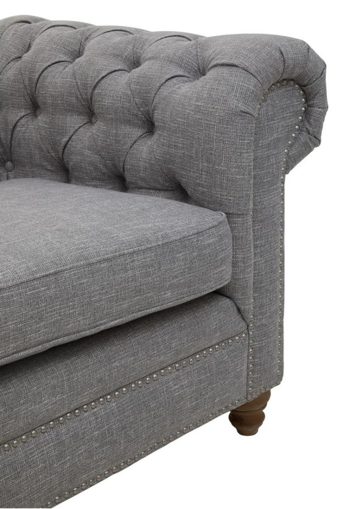 Three-seat sofa upholstered in grey linen with a tufted backrest and rolled armrest, featuring wooden legs