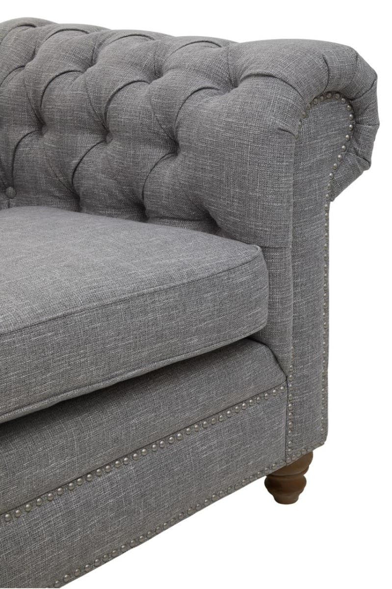 Three-seat sofa upholstered in grey linen with a tufted backrest and rolled armrest, featuring wooden legs
