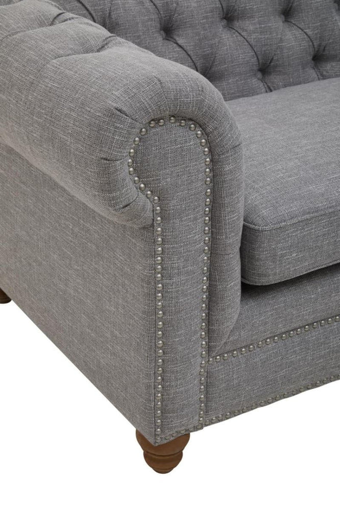 Grey linen sofa featuring a tufted backrest, rolled arms, and wooden legs. The fabric has a soft texture, and the overall design is elegant and modern, suitable for various interior styles