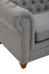 Grey linen sofa featuring a tufted backrest, rolled arms, and wooden legs. The fabric has a soft texture, and the overall design is elegant and modern, suitable for various interior styles