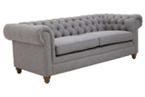 Three-seat sofa upholstered in grey linen with a tufted backrest and rolled arms, featuring wooden legs