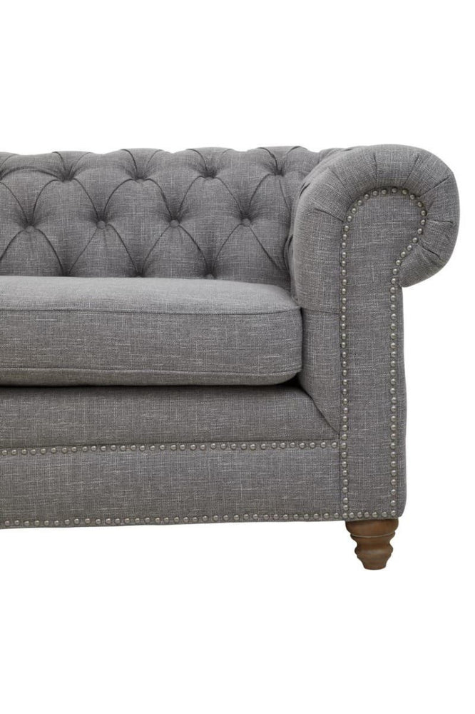 Three-seat sofa upholstered in grey linen with a tufted backrest and rolled arms, featuring wooden legs