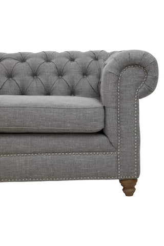 Three-seat sofa upholstered in grey linen with a tufted backrest and rolled arms, featuring wooden legs