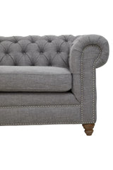 Three-seat sofa upholstered in grey linen with a tufted backrest and rolled arms, featuring wooden legs