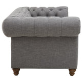 Three-seat sofa upholstered in grey linen with a tufted backrest and rounded armrest, featuring wooden legs for support. The design showcases a modern yet classic aesthetic suitable for various living spaces