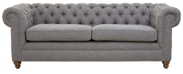 Three-seat sofa upholstered in grey linen with a tufted backrest and rolled arms, featuring wooden legs in a light finish