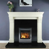 Modern wood burning stove set in cream fireplace surround with black hearth