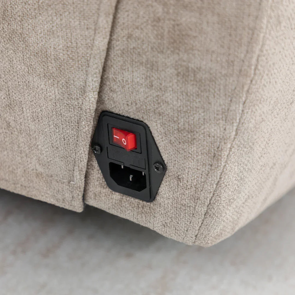 Close up of fabric recliner sofa power switch and plug socket panel
