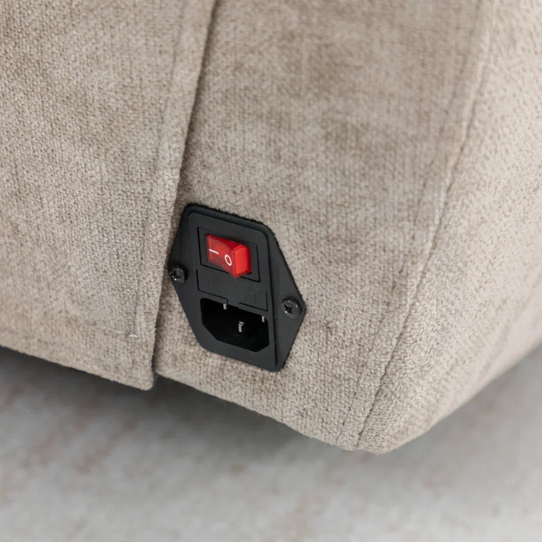 Close up of fabric recliner sofa power switch and plug socket panel