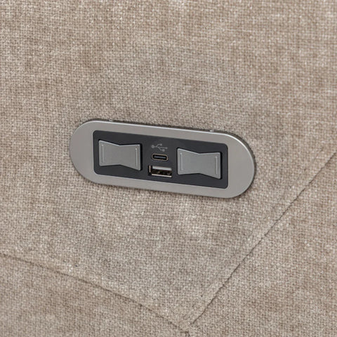 Close-up of beige fabric sofa arm with built-in USB and USB-C charging ports